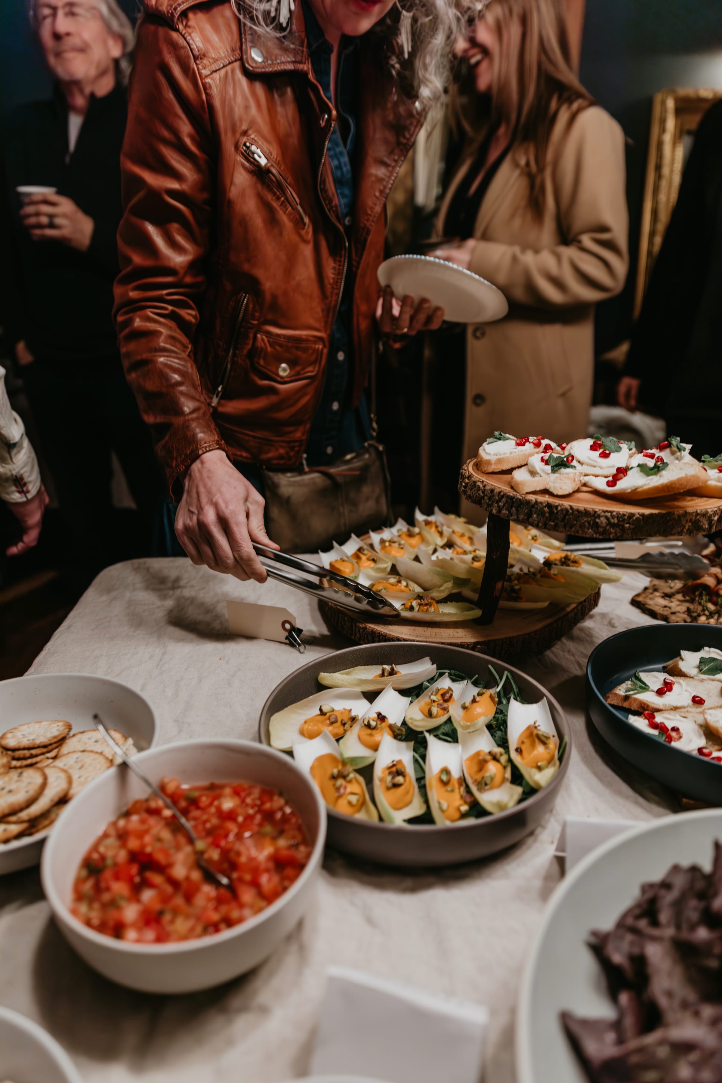 Guests filling plates from the buffet at a mixer